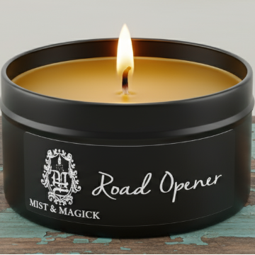 Lit Road Opener candle on blue-green board