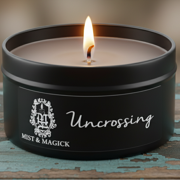 Lit Uncrossing candle on blue-green board